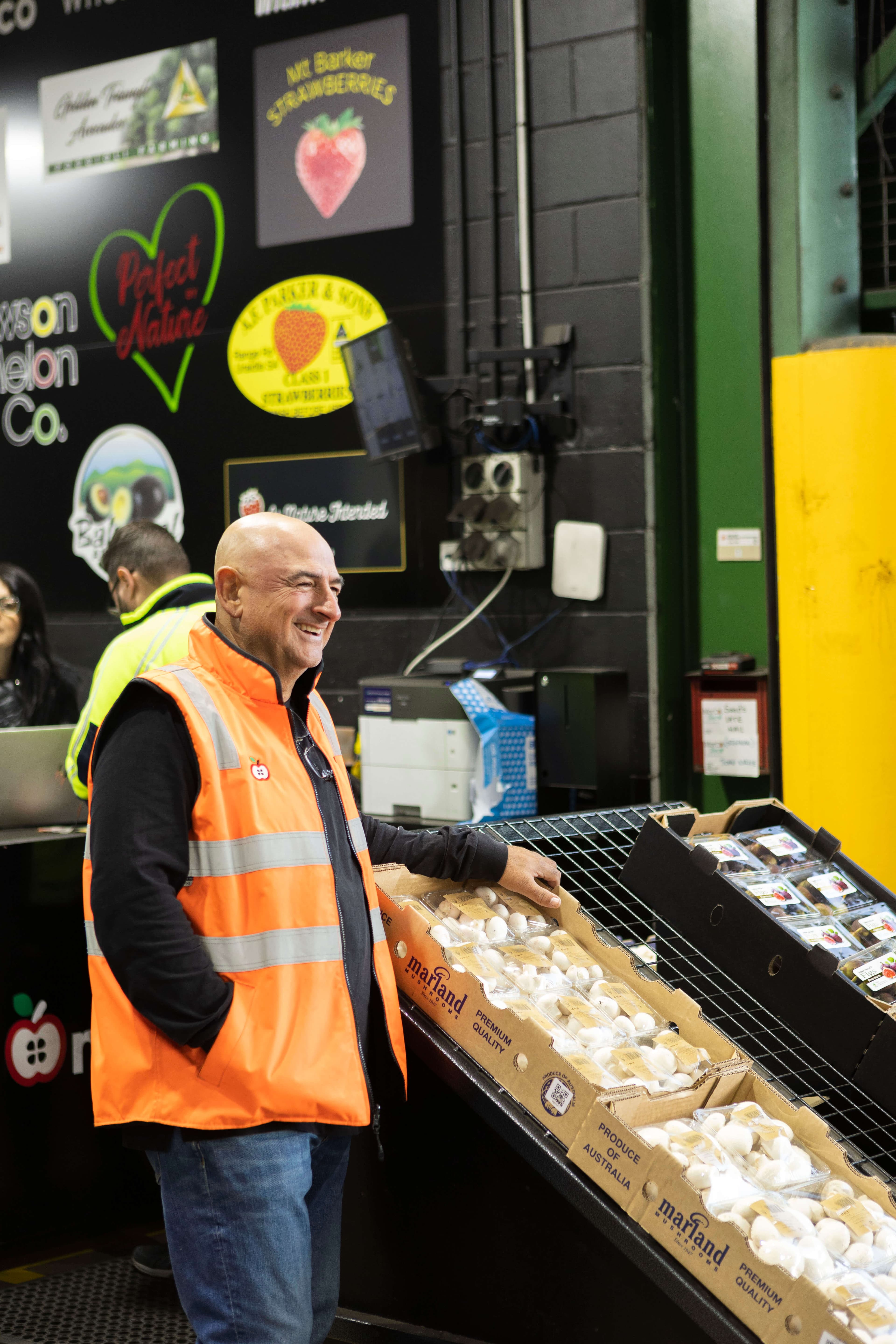 Morco staff member with a customer at the fruit market